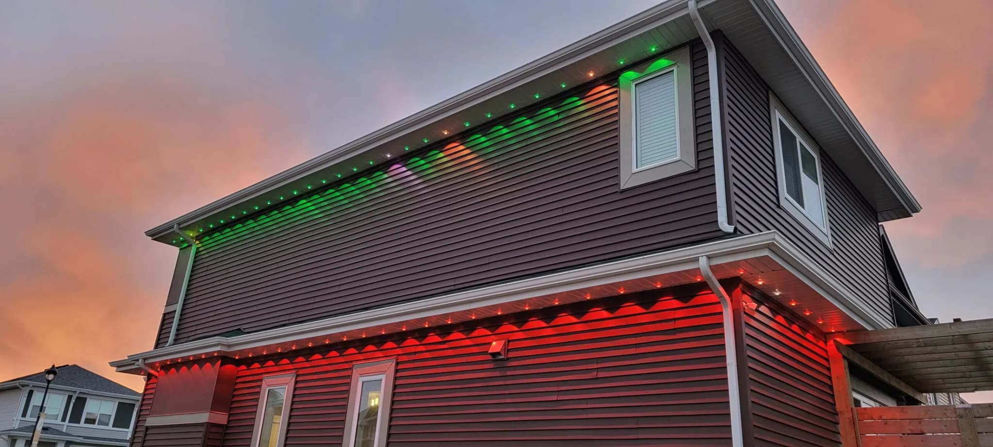 Wide home elevation lit end to end with permanent LED track lighting
