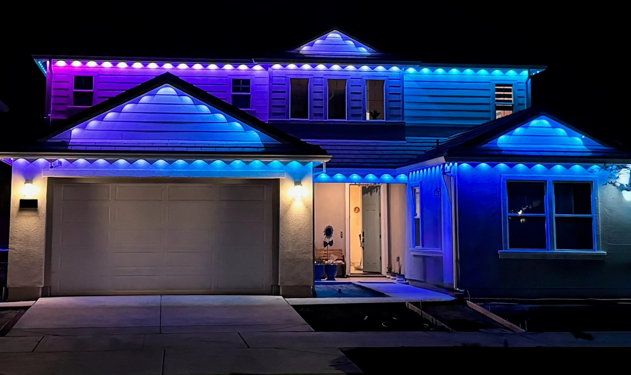 Homeowner measuring the front eave of a two-storey house with a tape measure before ordering C9 Christmas lights in Ontario