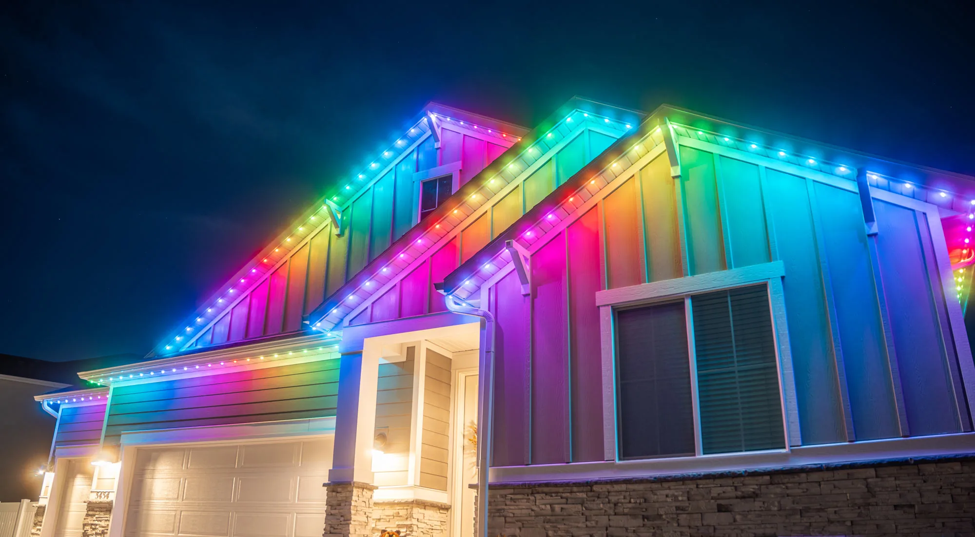 Wide view of a completed permanent LED lighting install running the full width of a home